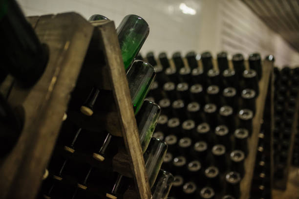 istock Storage hall of white sparkling wine bottles in the winery cellar 1311956302