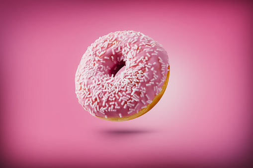 Freshly baked donuts isolated on colourful background