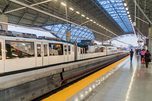 London, UK - 25 August, 2022: blurred motion of a subway train as it departs the modern architecture of the newly built Battersea Power Station underground station on the London Underground network.