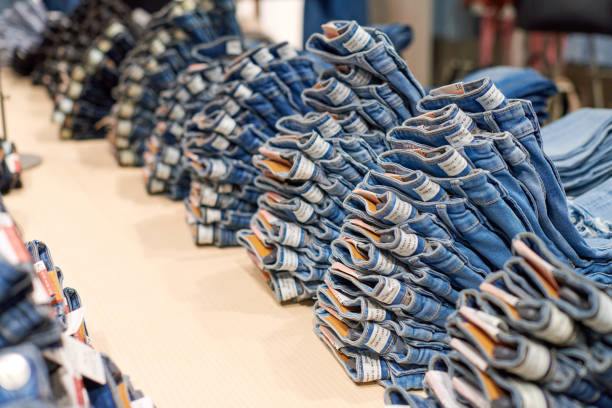 istock Denim jeans stack on wood table in clothing store, shopping 1311959836