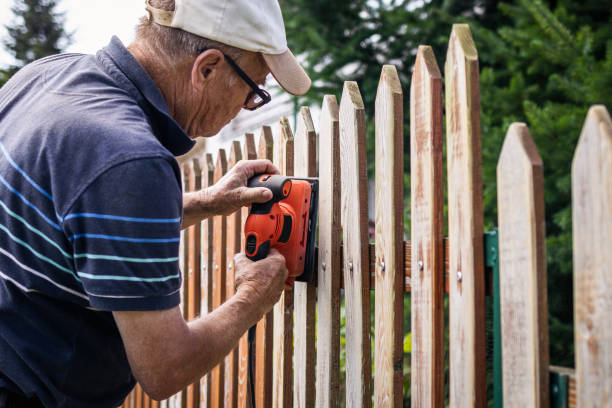 istock Working senior man sanding picket fence at backyard 1311960143