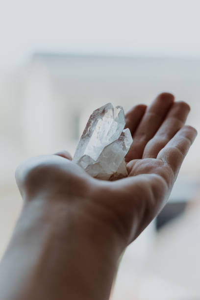istock Close up hand with white clear crystal spiritual 1311961072
