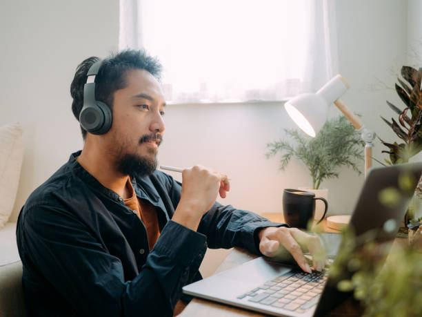 istock Asian man wear headset making conference call. 1311961506