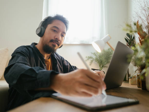 istock Asian man wear headset making conference call. 1311961522