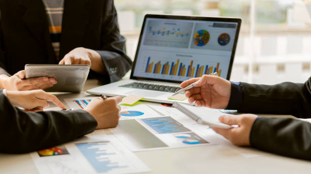 istock A businessman sits at the graph analysis desk. On graphics and charts with office calculators 1311961651