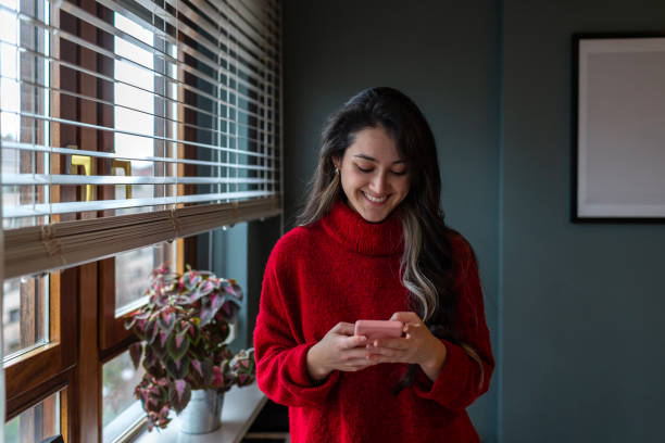 istock Smiling young girl chatting on her cell phone 1311962648