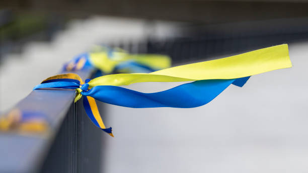 Ribbons in the colors of the national flag of Ukraine are tied to the handrail. stock photo
