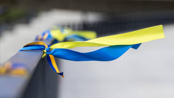 Ribbons in the colors of the national flag of Ukraine are tied to the handrail. Ribbons in the colors of the national flag of Ukraine are tied to the handrail. Yellow-blue tapes. ukraine flag stock pictures, royalty-free photos & images