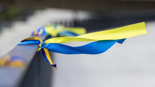 Ribbons in the colors of the national flag of Ukraine are tied to the handrail. Yellow-blue tapes.