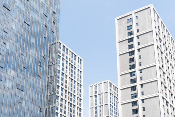 istock Modern office buildings under blue sky and white clouds 1311964802