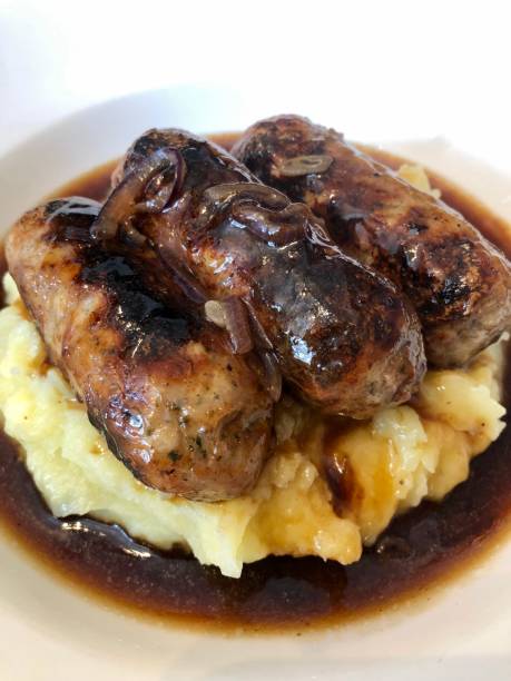 istock Traditional british dish, sausage and mash potatoes with onion gravy 1311965892