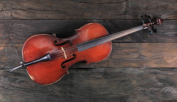 istock cello isolated on wooden background 1311969342