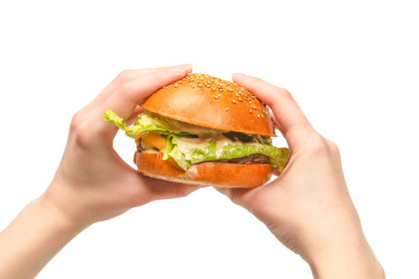 istock Hamburger in woman hands isolated on a white background. 1311969396