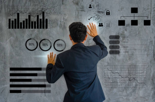 istock businessman turned his back on a suit a graph and chart on a gray wall as a background. Business planning Concept strategy. 1311969976