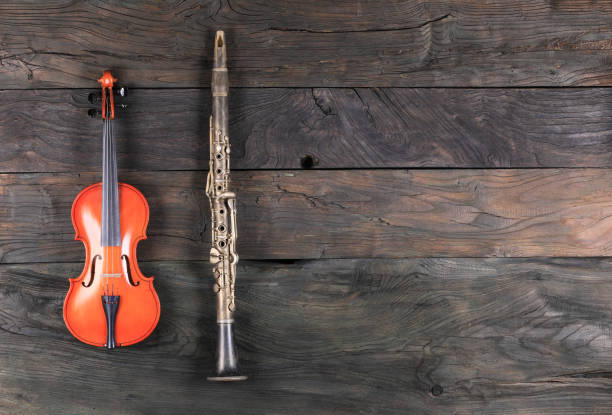 istock violin and clarinet isolated on wooden background 1311969978