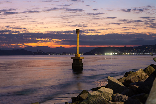View of the city of Santos during a sunset. In the foreground is the landmark where Martim Afonso de Souza landed in Brazil in 1532.