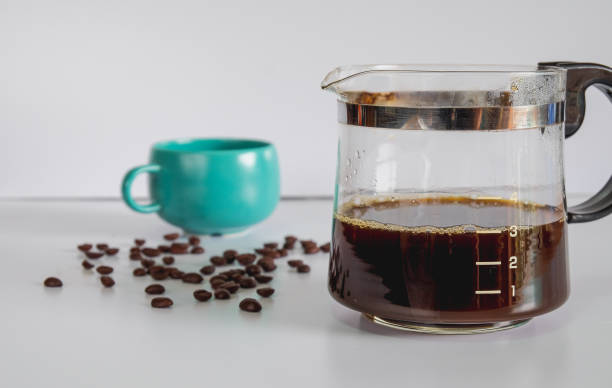 istock Coffee jar glass with cup and coffee maker on background. 1311973636