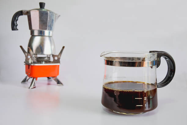 istock Coffee jar glass with cup and coffee maker on background. 1311973641