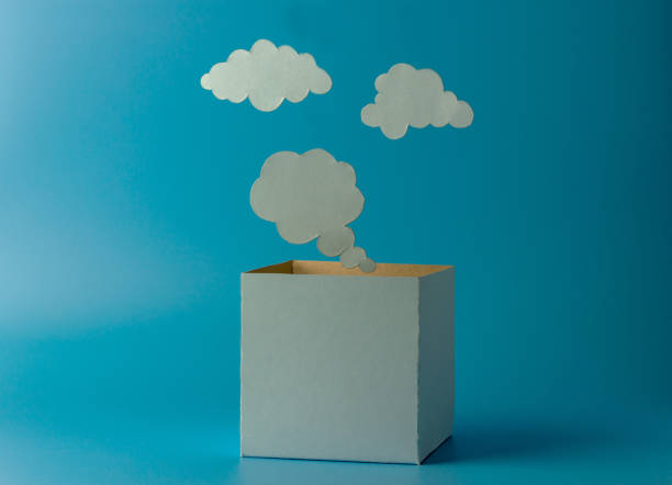 istock Box and clouds or thoughts from paper on a blue background. 1311976469