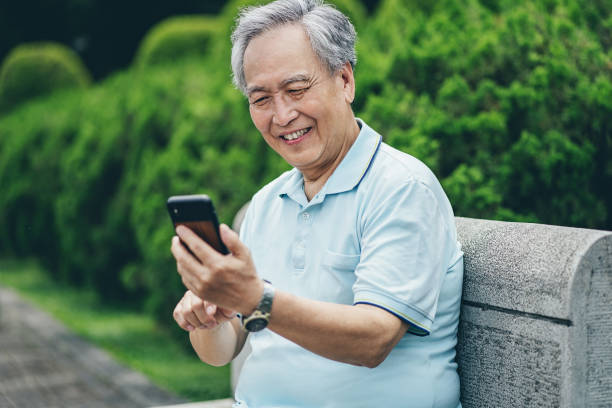 istock Smiling senior man with cell phone 1311977359