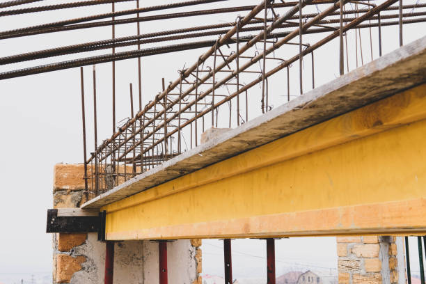 istock Monolithic frame construction of the building. Massive brick walls. Frame for walls. Reinforcement metal framework for concrete pouring. Concrete ceiling formwork. Home construction 1311977593
