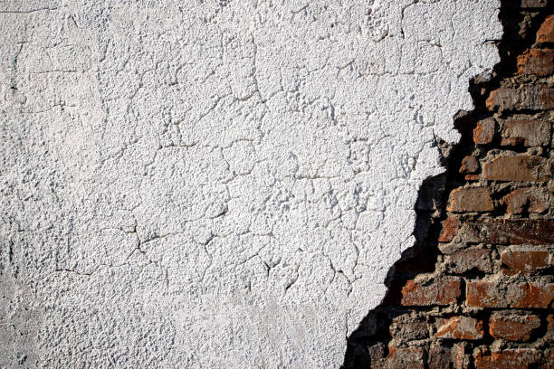 istock Peeling wallpaper. Old rough stone on cement pattern wall background. Vintage grunge plaster or concrete stucco surface. Natural material abstract structure backdrop. 1311977649