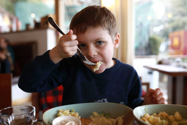 istock Child has cutlet in restaurant 1311978014