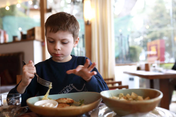 istock Kid eating pasta with cheese 1311978023