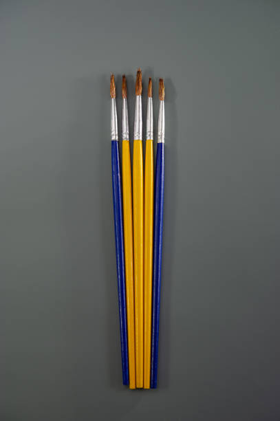 istock Artistic brushes lie on a dark gray background. 1311979123
