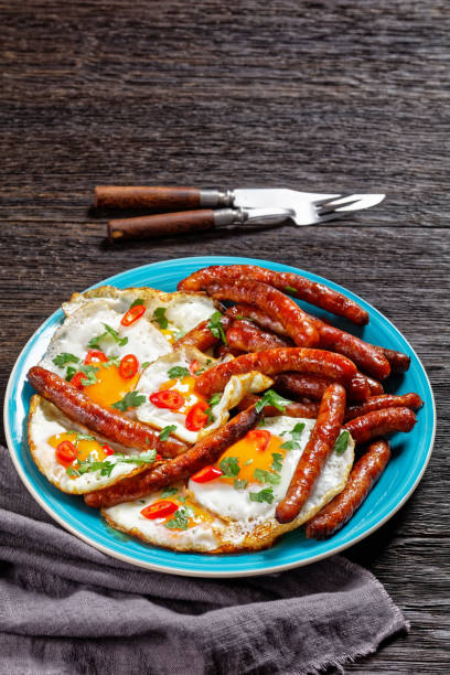 istock crispy fried sausages with fried eggs on a plate on a wooden table, horizontal view from above, mexican cuisine 1311980583