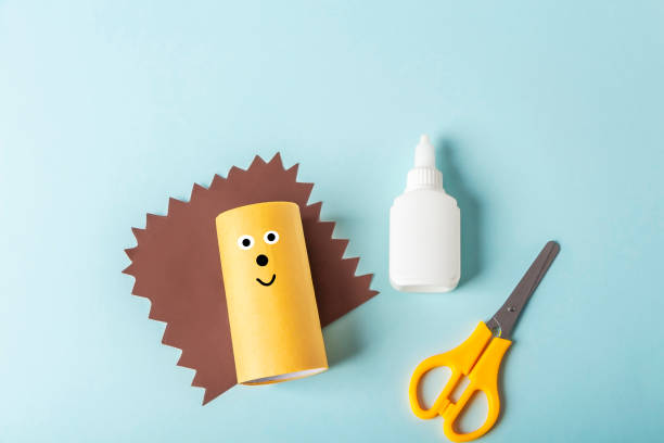 istock DIY and kids creativity. Step by step instruction: how to make hedgehog from toilet roll tube. Step2 glue roll with paper and draw  eyes and nose. Children Craft workshop. Eco-friendly reuse recycle. 1311981317