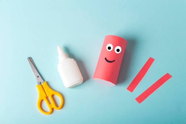 DIY and kids creativity. Step by step instruction: how to make octopus from toilet roll tube. Step2 glue roll with paper and cut out tentacles. Children Craft workshop. Eco-friendly reuse recycle.