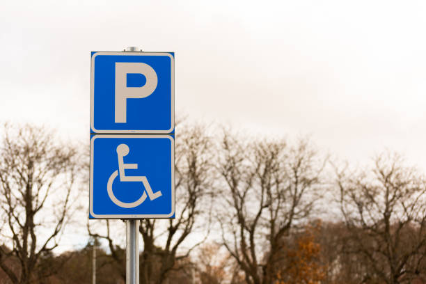 istock Handicap parking sign by a parking lot.. 1311982489