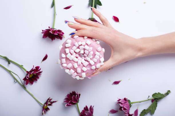 istock Pink donut and flowers on white background 1311982641