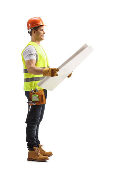 istock Full length profile shot of a construction worker checking a blueprint 1311982808