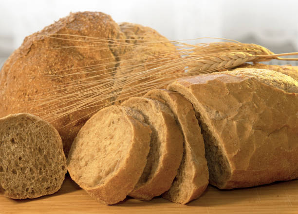 istock Various breads and dry wheat on wooden background 1311983973