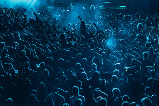 istock Concert crowd in front of stage lights 1311985630