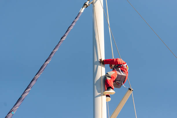 Sevastopol. Crimea. Autumn 2020. The yachtsman climbed the mast. Repair of the device for measuring wind speed and direction.