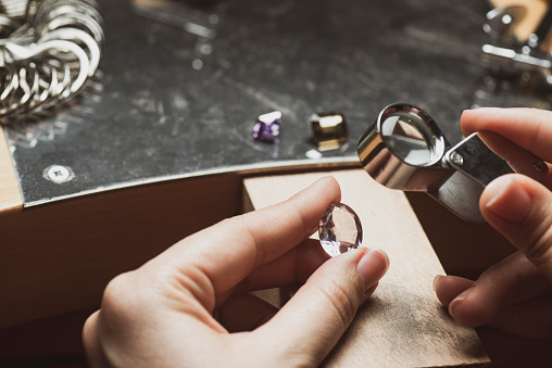 Jewellery equipment and semi-precious gem on the workbench.
