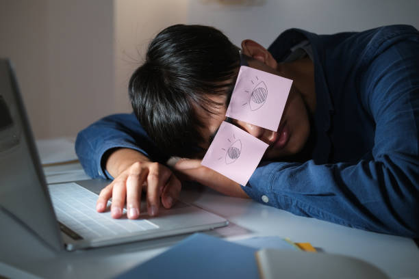 istock Exhausted tired workaholic young man with painted eyes on stickers 1311988187
