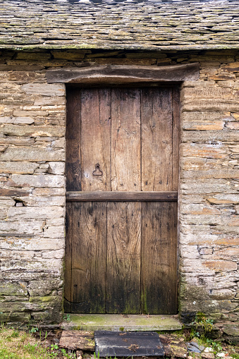 Wooden door an old stone rural house in Galicia Spain