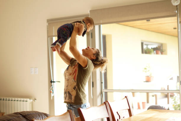 istock woman playing with her baby 1311989955