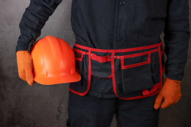 istock worker in a special uniform holds a protective helmet 1311990807