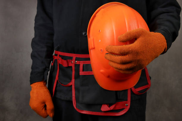 istock Installer in a special uniform with a helmet in hand 1311990894