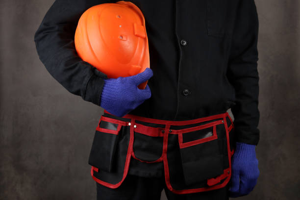 istock Installer in a special uniform with a helmet in hand 1311990911