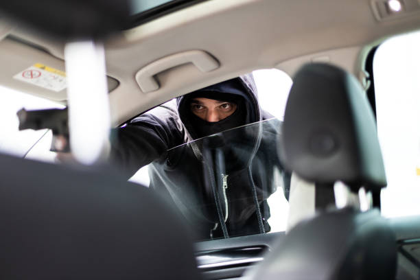 car jacker with a gun threatened driver - burglary thief fear burglar imagens e fotografias de stock