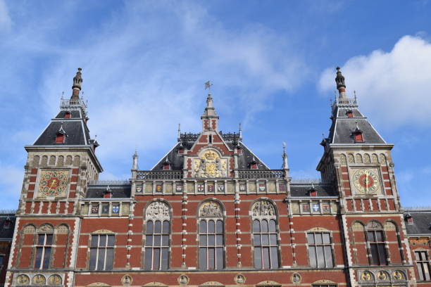 istock Amsterdam Central train station, old beautiful architecture and vibrant colored buildings. 1311992538
