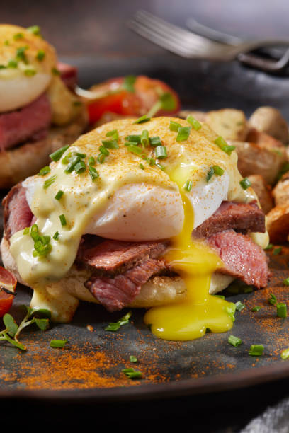 Medium Rare Steak Benedict on Toasted English Muffin Medium Rare Steak Benedict on Toasted English Muffins with Roast Potatoes and Cherry Tomatoes steak and eggs breakfast stock pictures, royalty-free photos & images