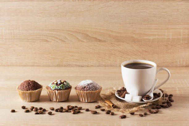 istock Muffins and a cup of coffee on a light background 1312001363