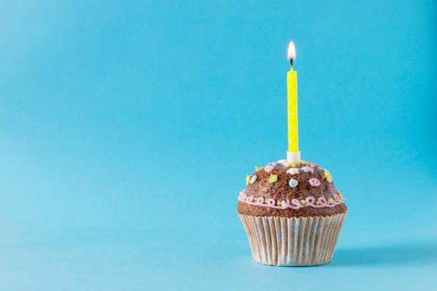 istock homemade muffin, cupcake with candle on a blue background 1312001462